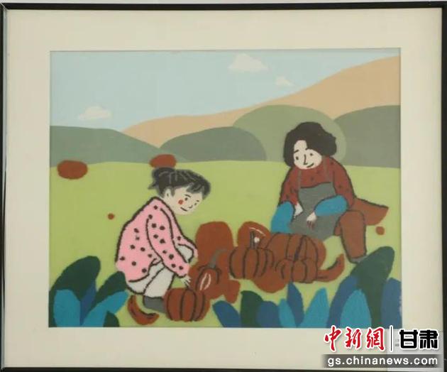 嘉峪關(guān)市新城鎮(zhèn)新城村農(nóng)業(yè)產(chǎn)業(yè)園區(qū)內(nèi)，母女兩人在摘南瓜。刺繡 馬艾米乃 繡稿 敬紅霞