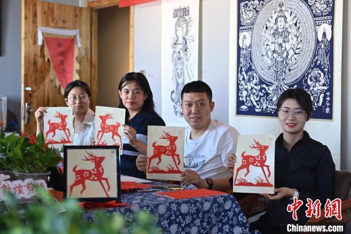 6月6日，在甘肅敦煌青年夜校課程中，青年學(xué)員展示學(xué)習(xí)敦煌非遺剪紙的成果。李亞龍 攝　　